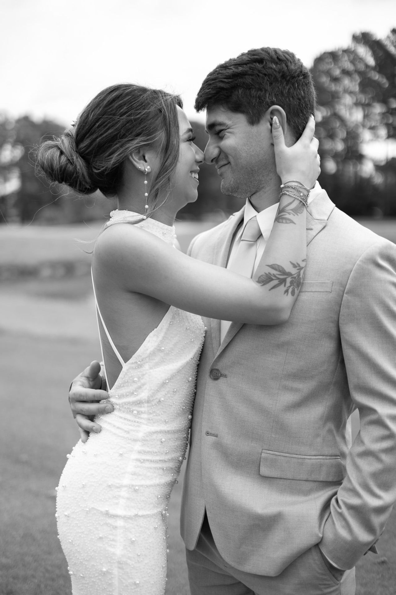 Real couple — black and white portrait with bridal low bun and pearl-drop earrings